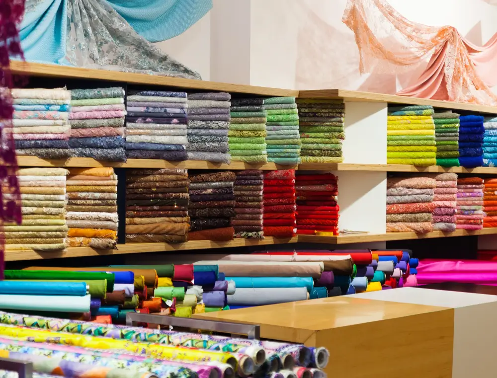 Finished fabric stacked by colour and grade in the warehouse