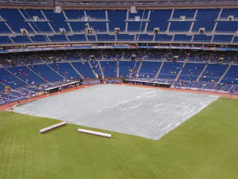 Athletic field cover rolled across a sports pitch