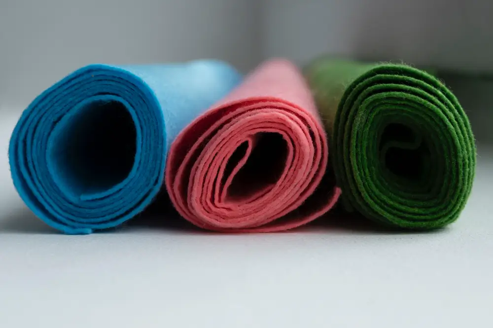 Rolls of cotton canvas and synthetic tarp fabric