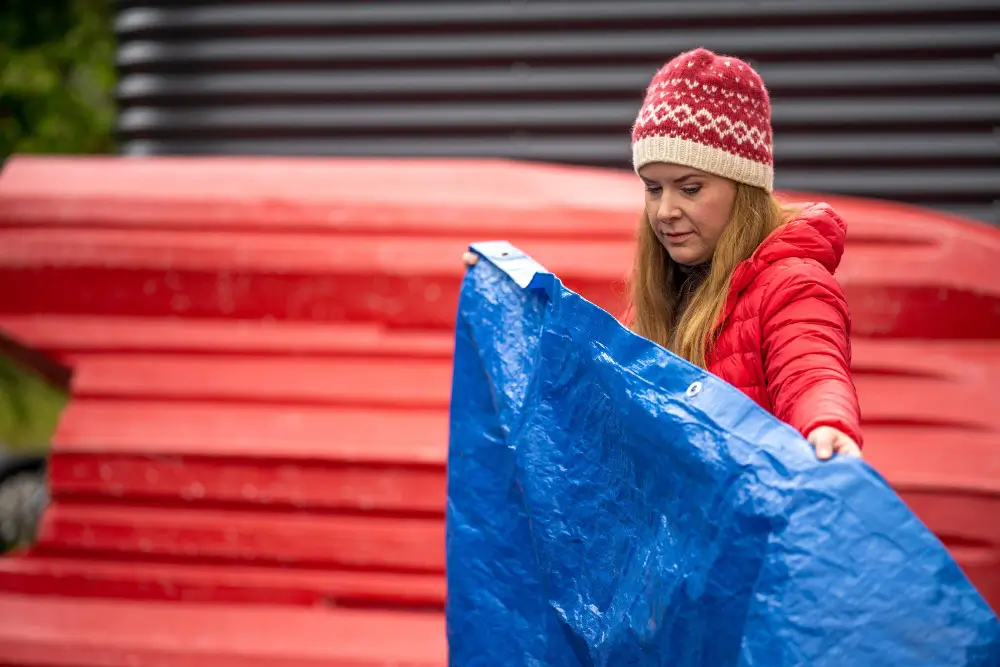 Blue polyethylene tarps covering stored goods